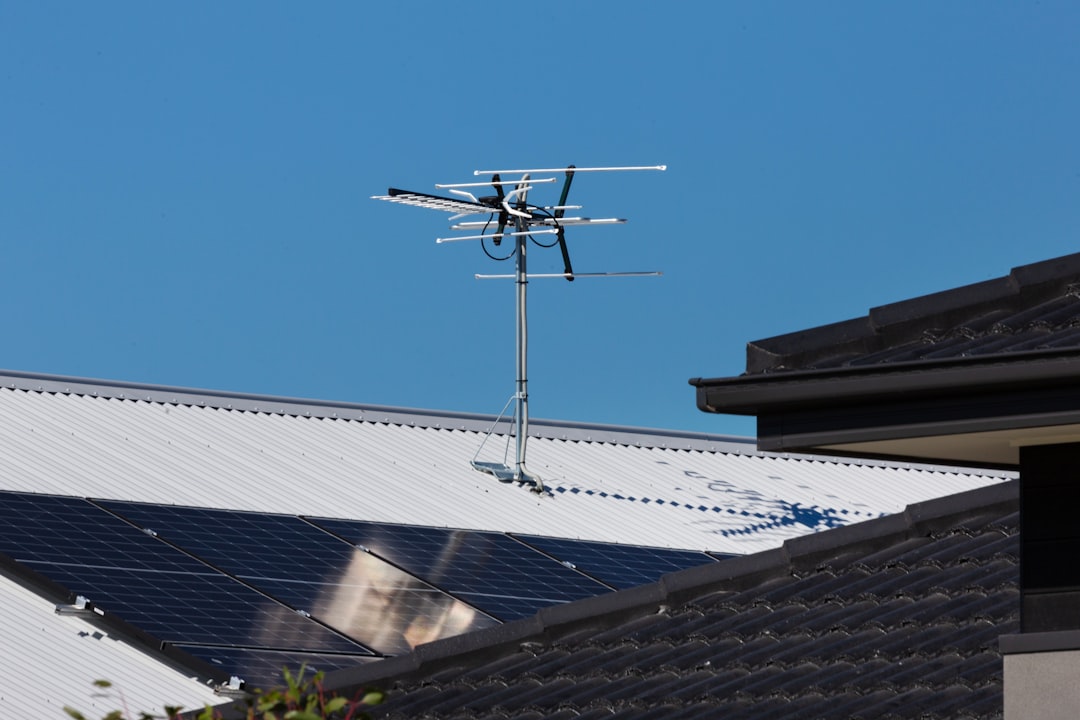 Rooftop solar panels with TV antenna.